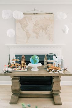 a table topped with lots of food on top of a hard wood floored floor