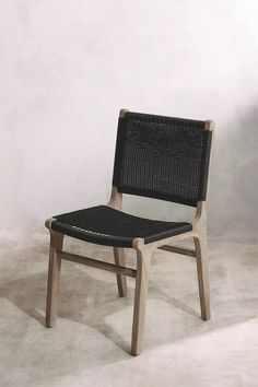 a chair made out of wood and wicker sitting on top of a white floor