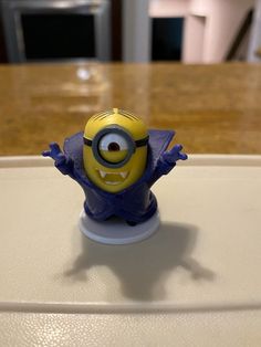 a small toy figure sitting on top of a table