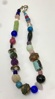 Huge, chunky, flashy assortment of precious & semiprecious elements. Includes natural hand carved jade, onyx, metal-inlaid opalite, turquoise, bone, obsidian, copper, Sterling, smoothed ancient Chinese glass, amethyst, rose quartz, and more. Purchased new from an artist's studio in the 1980s or 1990s, and never used; just stored in a jewelry box for decades. Perfect- like new. Sold as pictured. One Of A Kind Multicolor Eclectic Jewelry, Eclectic Multicolor One-of-a-kind Jewelry, Eclectic Jewelry With One Of A Kind Round Beads, Eclectic Jewelry With One-of-a-kind Round Beads, Spiritual Jade Jewelry With Large Beads, Eclectic One-of-a-kind Jewelry With Round Beads, Eclectic Large Beads Necklaces For Jewelry Making, Unique Natural Stones Beads And Cabochons For Jewelry Making, Handmade Eclectic Healing Jewelry