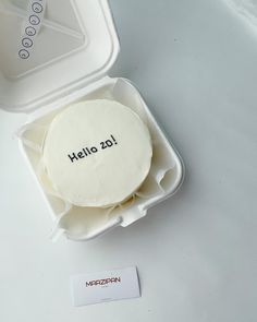 there is a cake in a container with the word hello 216 printed on it,