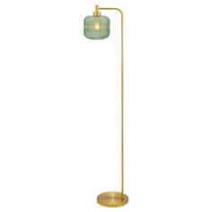 a gold floor lamp with a green glass shade