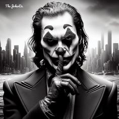 the joker is holding his finger up to his mouth in front of a cityscape