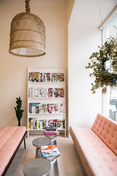 a living room with two couches and a coffee table in front of a book shelf