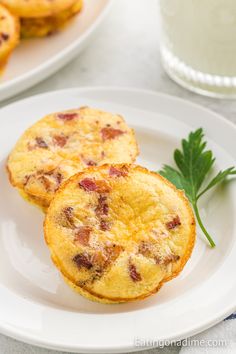 two muffins sitting on top of a white plate