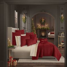 a bedroom decorated for christmas with red and white bedding, fireplace and holiday decorations