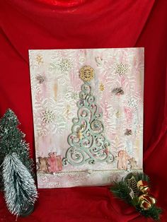 a christmas card with a tree on it next to two small pine trees and decorations