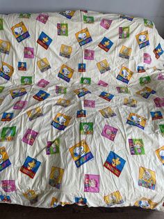 there is a bed covered with children's books on the sheets and pillow cases