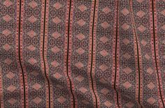 a red and blue patterned fabric with small squares on it's side, in the middle