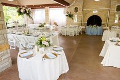 a banquet hall with tables and chairs set up for formal function