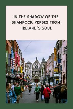 people walking down the street in front of some buildings with words that read in the shadow of the shamrock versus from ireland's soul