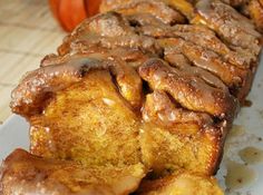 there is a long pastry with icing on the table next to pumpkins and other decorations