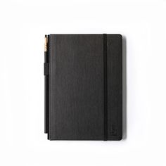 a black notebook sitting on top of a white surface