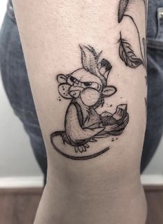 a small mouse tattoo on the leg