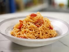 a white plate topped with spaghetti and sauce