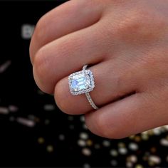 a woman's hand with a diamond ring on it