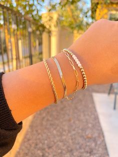 Endless options of bracelet stacking ideas! All of these bracelets are 14K Gold Filled. This is the closest you will get to real gold without having to break the bank! Wear these 24/7, you never have to take them off. Wear them in the shower, pool, even when working out! Depending on the bracelet the sizing varies: +Gold/White bead  + Link Chain         Please provide the custom size for these 2 bracelets in the notes        X Small: 6.0"        Small: 6.5" (Most common)        Medium: 7.0"        Large: 7.5" + Snake chain: 7" + 1" extender  + Rope chain: 7" Please contact me if you have any other questions or concerns! I am always here to help! Trendy 14k Gold Bracelets For Everyday Wear, Trendy 14k Gold Everyday Bracelet, Trendy Everyday 14k Gold Bracelets, Trendy Everyday 14k Gold Bracelet, Stacked Bangle Bracelets As Gift, Stackable Yellow Gold Beaded Bracelets For Everyday, Trendy Stackable Yellow Gold Bracelet, Elegant Stacked Gold Bracelets, Everyday Stackable Yellow Gold Beaded Bracelet