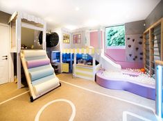 a child's play room with slides and toys