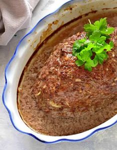 a close up of a casserole dish with meat and garnishes