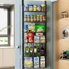 a pantry door is open to show the food and drink items on display in it