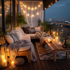 an outdoor living area with candles and lights on the ceiling, covered in white curtains