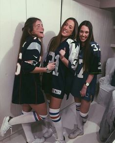 three girls are standing in the locker room