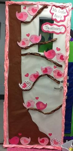 a bulletin board decorated with pink and brown birds