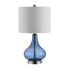 a blue glass lamp with a white shade on it's side and a silver base