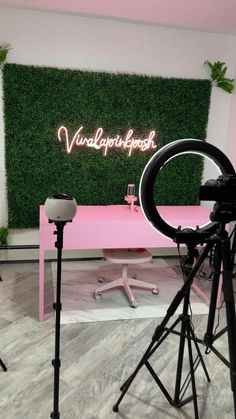 a pink table and chairs in front of a green wall with the word'victoria queen'written on it