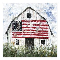 an american flag painted on the side of a white barn with green grass and flowers