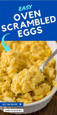 easy oven scrambled eggs in a white bowl with a blue sign over the top that says easy oven scrambled eggs