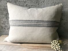 a white pillow sitting on top of a wooden table