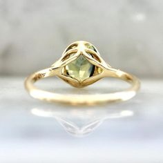 Why I Love It: This divine morsel features an ethereal 1.43 carat oval cut parti sapphire center with stunning hues of green, blue, and yellow. A perfectly matched pair of white round brilliant cut diamonds in the shoulders and delicious 14k Yellow Gold finish off this stunning engagement ring. Sits low and flush to the finger. The Details: 14k Yellow Gold 1.43 Carat Green Oval Cut Parti Sapphire Madagascar Origin .04 Carats Total of White Round Brilliant Cut Canadian Diamonds Current Ring Size Yellow Sapphire Ring With Center Stone, Fine Jewelry Green Sapphire Ring With Rose Cut Diamonds, Green Sapphire Ring With Rose Cut Diamonds, Elegant Yellow Sapphire Wedding Ring, Green Diamond Ring With Rose Cut, Yellow Sapphire Rings With Diamond Cut, Unique Yellow Gold Sapphire Ring With Rose Cut Diamonds, Elegant Yellow Sapphire Round Ring, Sapphire Birthstone Ring With Rose Cut Diamonds