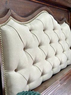 a close up of a wooden headboard with buttons and nailing on the back