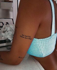 a woman with a tattoo on her left arm and the words for real love are written in cursive font