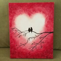 two birds sitting on a branch in front of a heart - shaped painting with red background