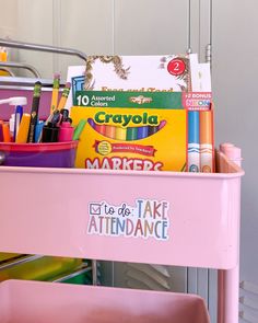 a pink cart filled with lots of school supplies