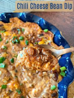 a blue plate topped with meatballs and cheese covered in gravy next to tortilla chips