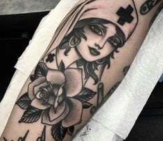 a woman's arm with a cross on it and roses in the corner,