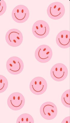 a pink background with smiley faces on it