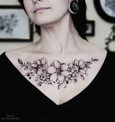 a woman with black and white flowers on her chest