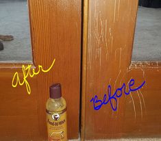 a brown door with blue writing on it next to a bottle of mustard and a cat