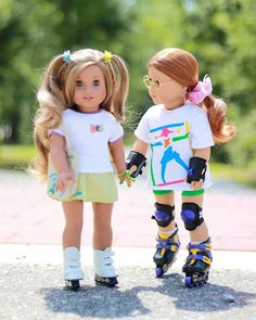 two dolls standing next to each other wearing roller skates and holding their hands together