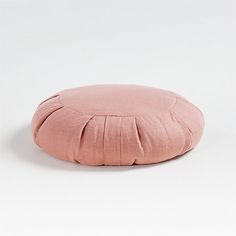 a pink round cushion on a white background