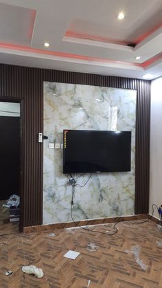 a tv mounted to the side of a wall in a room that is being remodeled