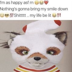 a stuffed animal wearing a sweater and smiling at someone's face with emotication on it