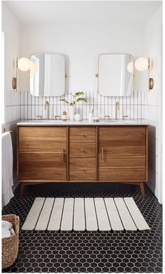 a bathroom with two sinks and a rug on the floor next to it is an ad for west elm