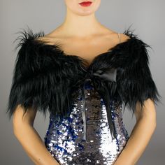 a mannequin with sequins and feathers on it's head wearing a dress