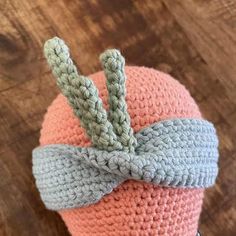 a crocheted hat with a bow on top