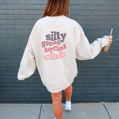 ✨ Step into comfort and style with my latest fall season sweatshirt design! This trendy oversized silly goose social club crewneck is all about silly vibes. A fun little expression to add a smile to your face. ✨The design is laid-back and casual, perfect for those lazy days or casual outings. This oversized unisex heavy blend pullover sweatshirt is cozy and comforting all in one. Made with a thick blend of cotton and polyester. It feels plush and soft, a perfect choice. ✨ Runs true to size ✨ Consider sizing up for oversized look ✨ Model sized up 2 sizes for this fit ✨ Loose fit ✨ 50% cotton, 50% polyester ✨ Medium-heavy fabric ✨ Tear-away label Casual Lettering Sweatshirt For Spring, Fall Slogan Sweatshirt For Leisure, Fall Leisure Sweatshirt With Slogan, Trendy Fall Sweatshirt With Lettering, Oversized Sweatshirt With Lettering For Loungewear, Oversized Lettering Sweatshirt For Fall, Oversized Fall Sweatshirt With Lettering, Peace Was Never An Option, College Crewneck